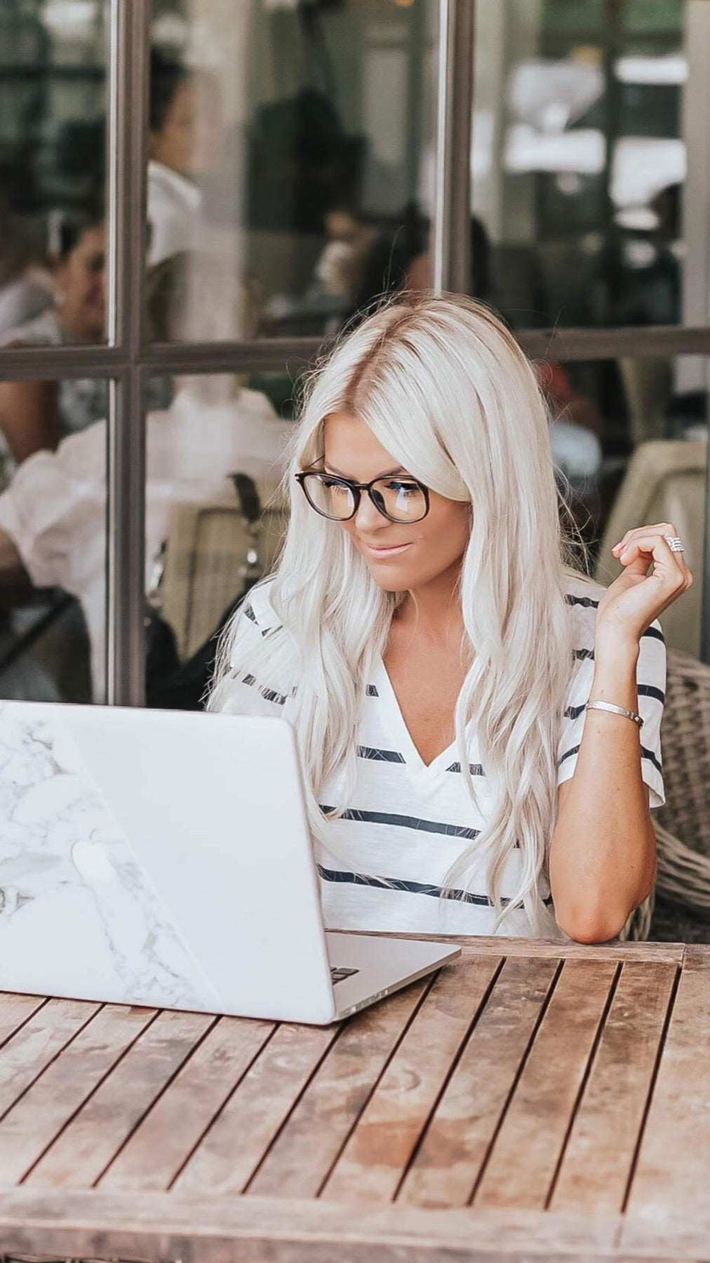 Woman working at a laptop in black LadyBoss glasses
