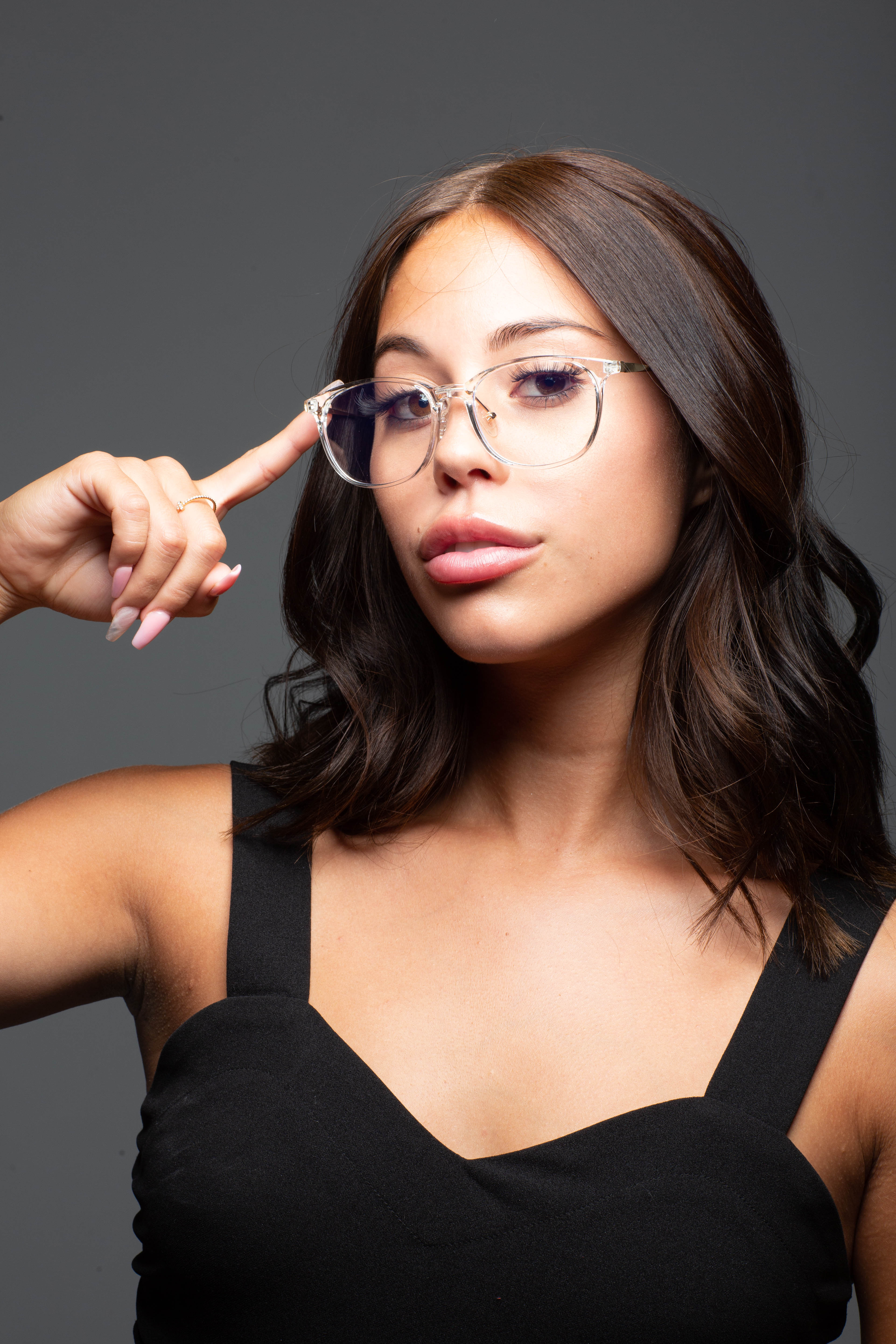 Model wearing LadyBoss Minimals eyeglasses in Crystal Clear #frame color_crystal clear
