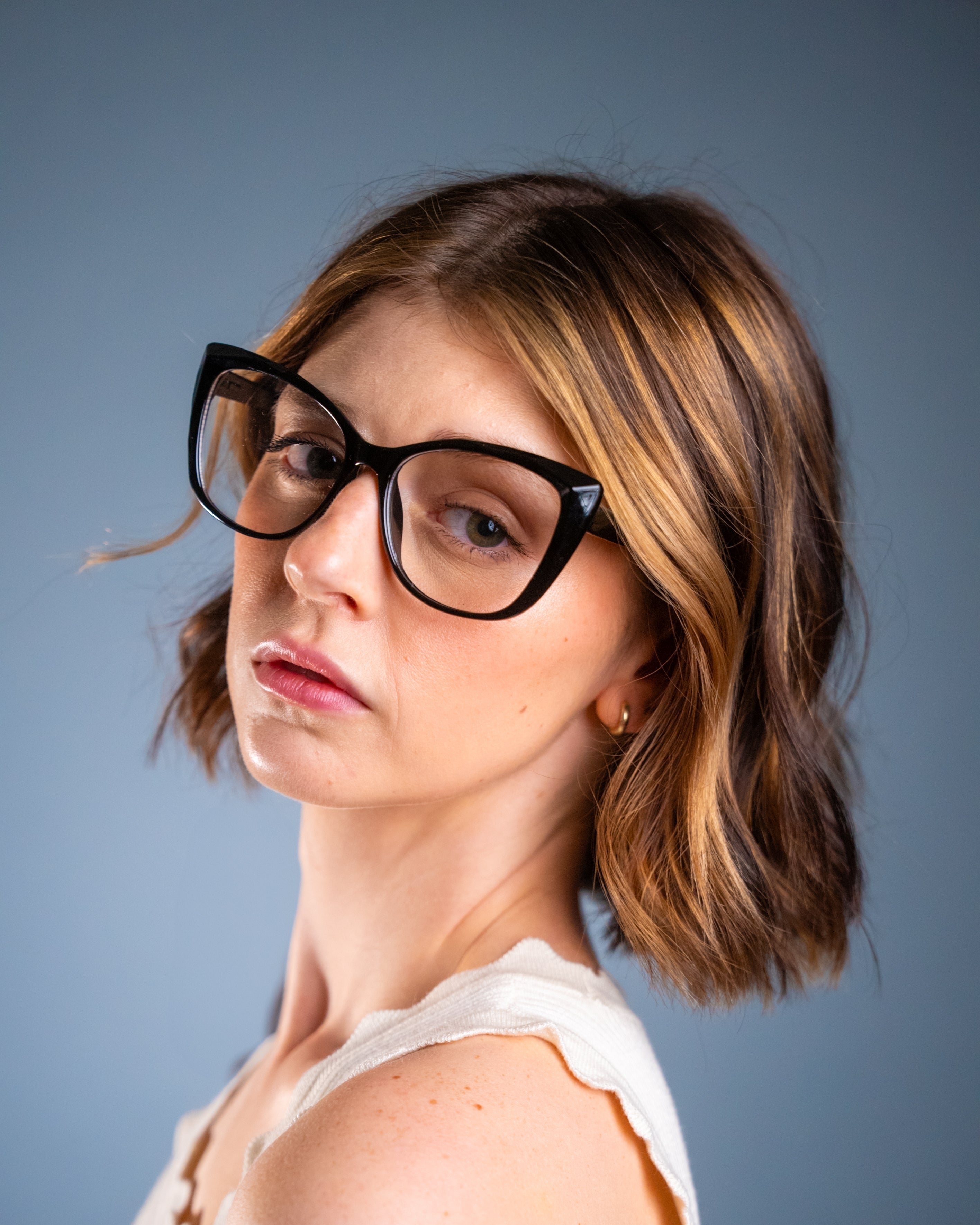 Model wearing LadyBoss Alloras eyeglasses in Black #frame color_black