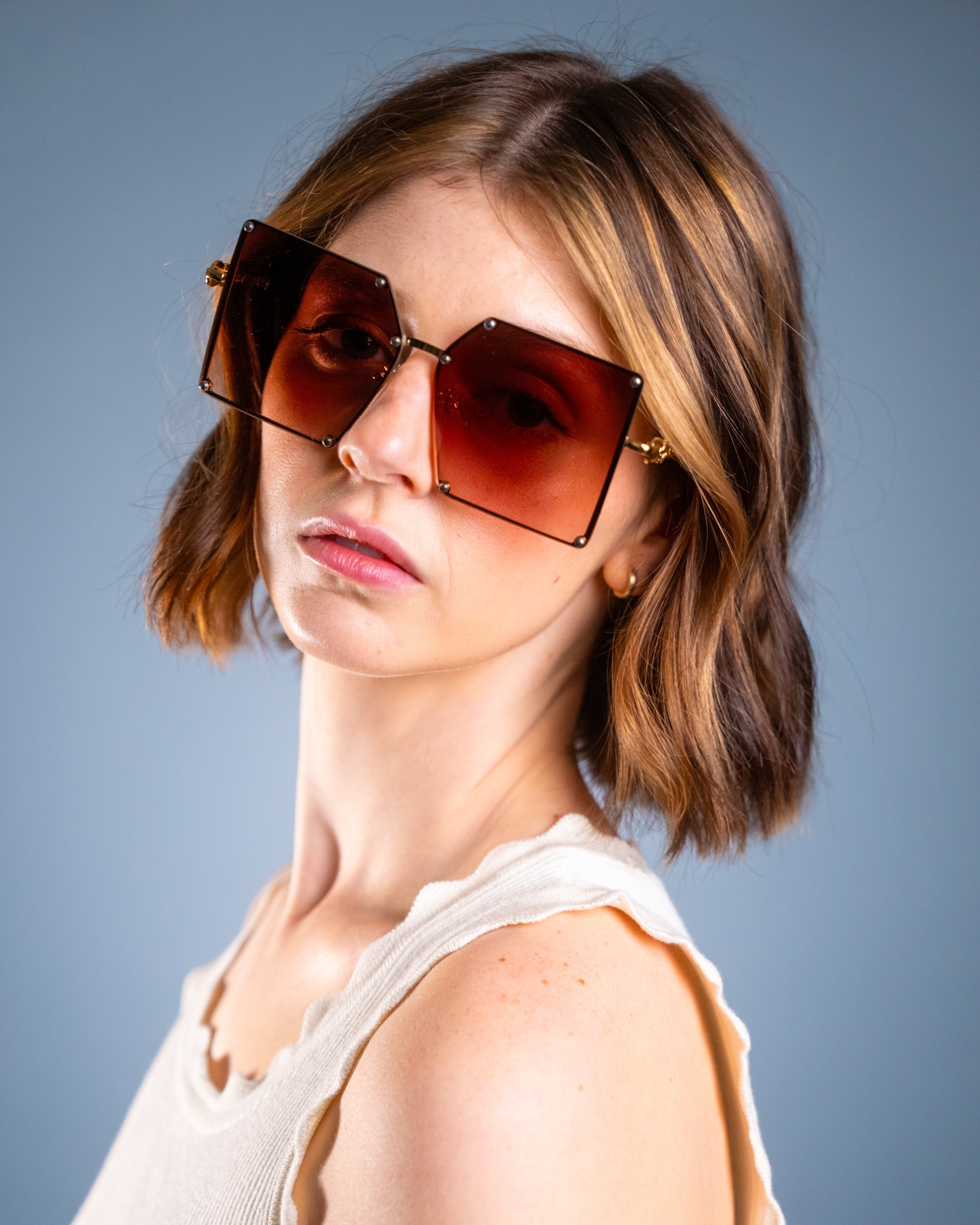 Model wearing LadyBoss Elevations sunglasses in Amber #frame color_amber