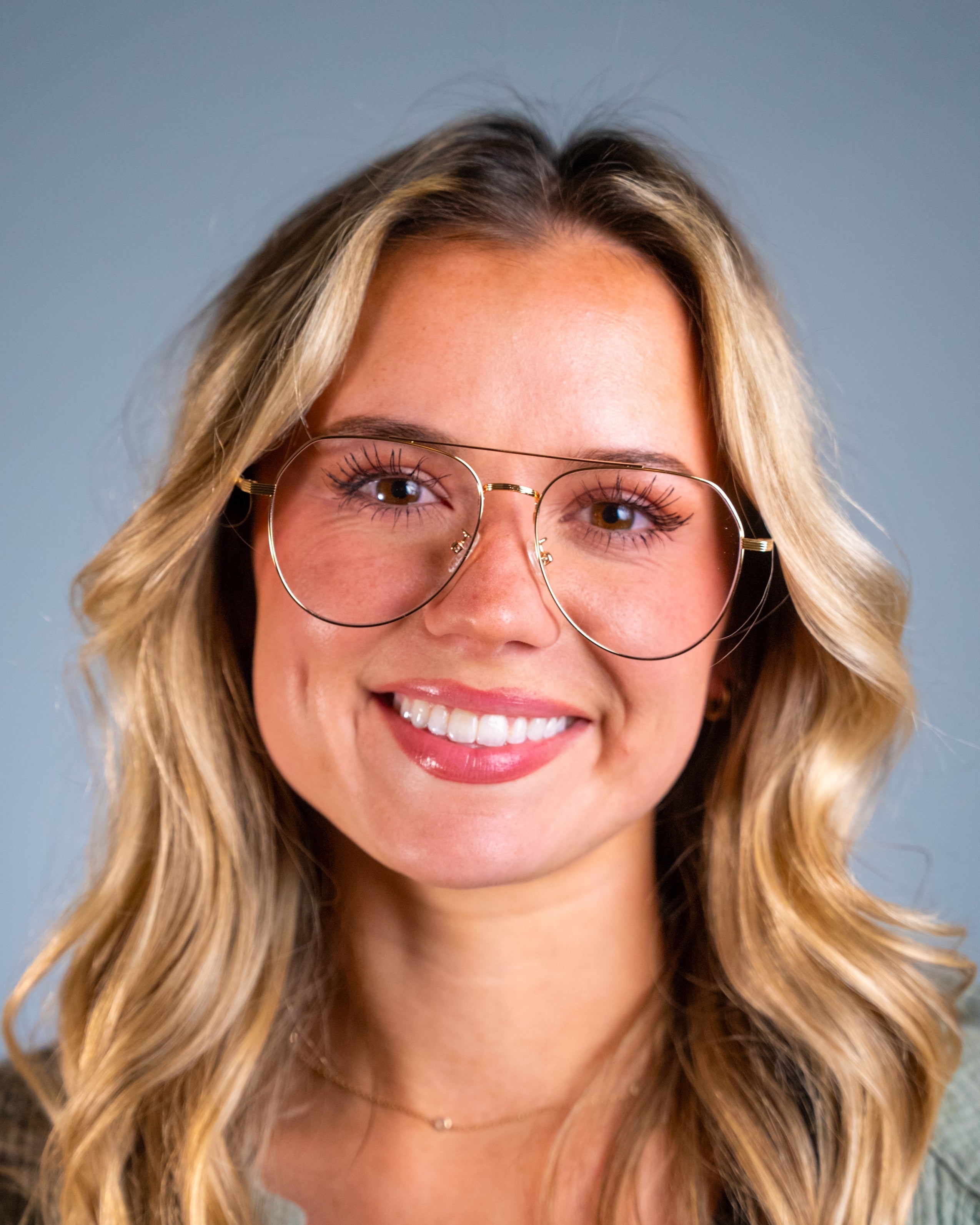 Model wearing LadyBoss Evocatives eyeglasses in Gold #frame color_gold