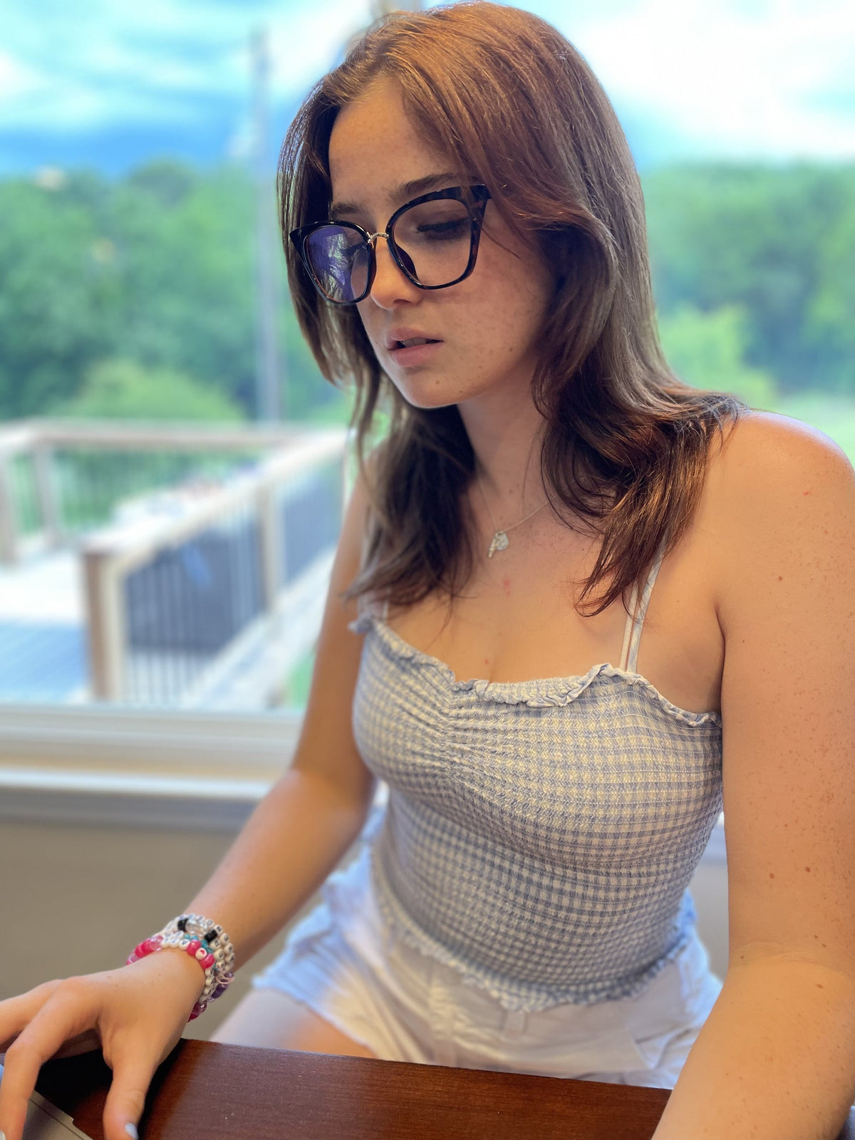 Woman working by a window in leopard LadyBoss glasses