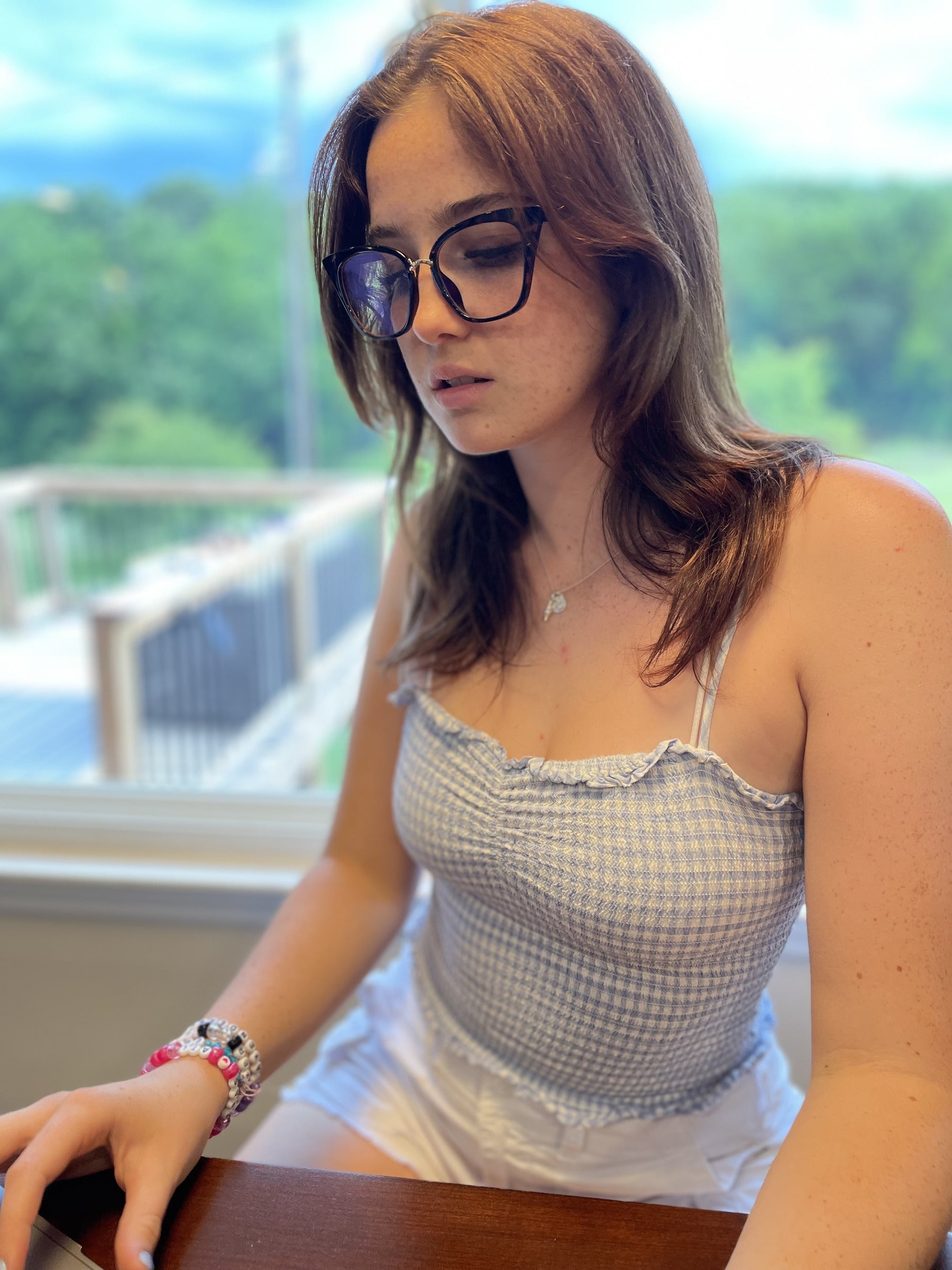 Woman working by a window in leopard LadyBoss glasses