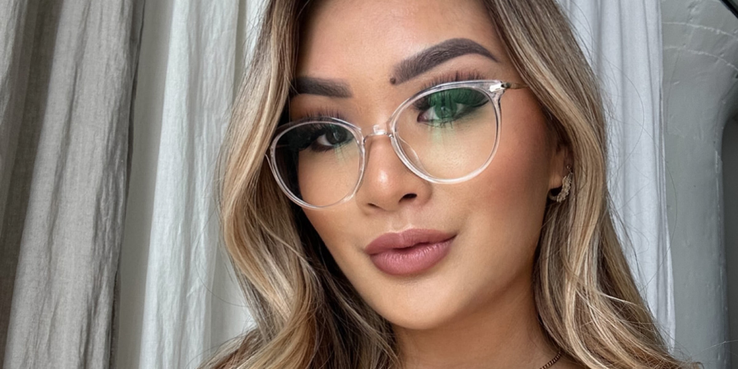 Woman wearing clear and gold LadyBoss glasses