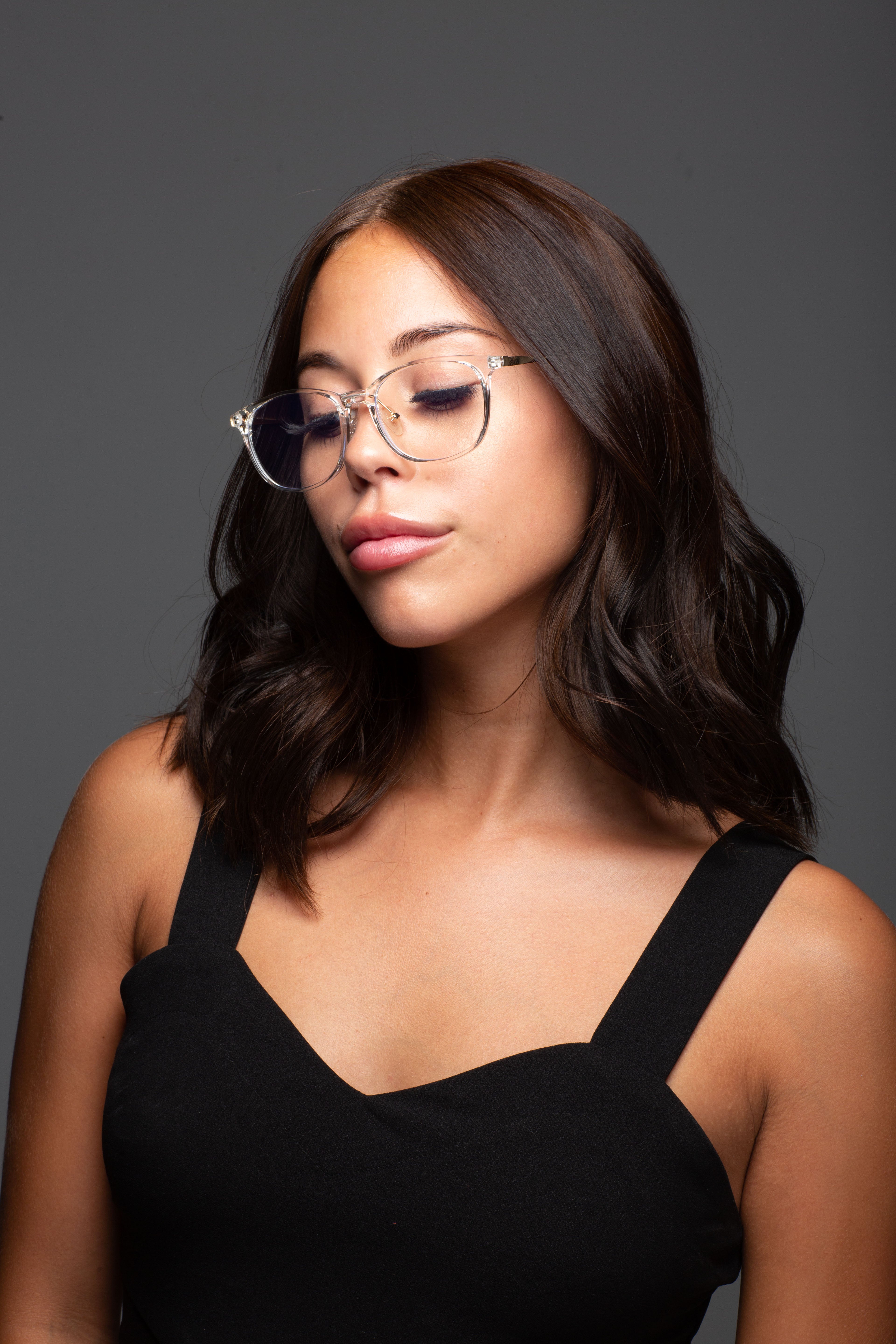 Model wearing LadyBoss Minimals eyeglasses in Crystal Clear #frame color_crystal clear