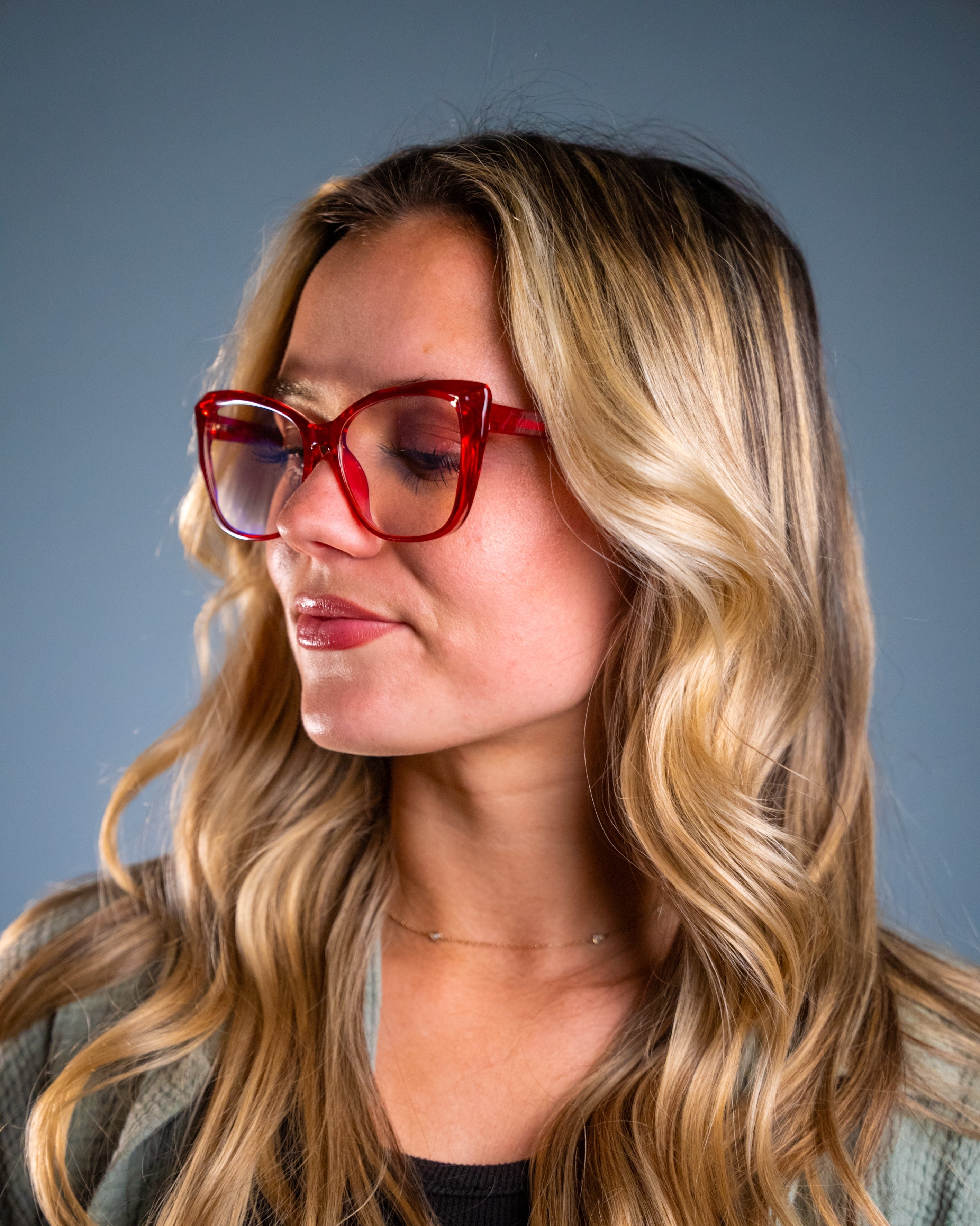 Model wearing LadyBoss Alloras eyeglasses in Cardinal Crystal #frame color_cardinal crystal