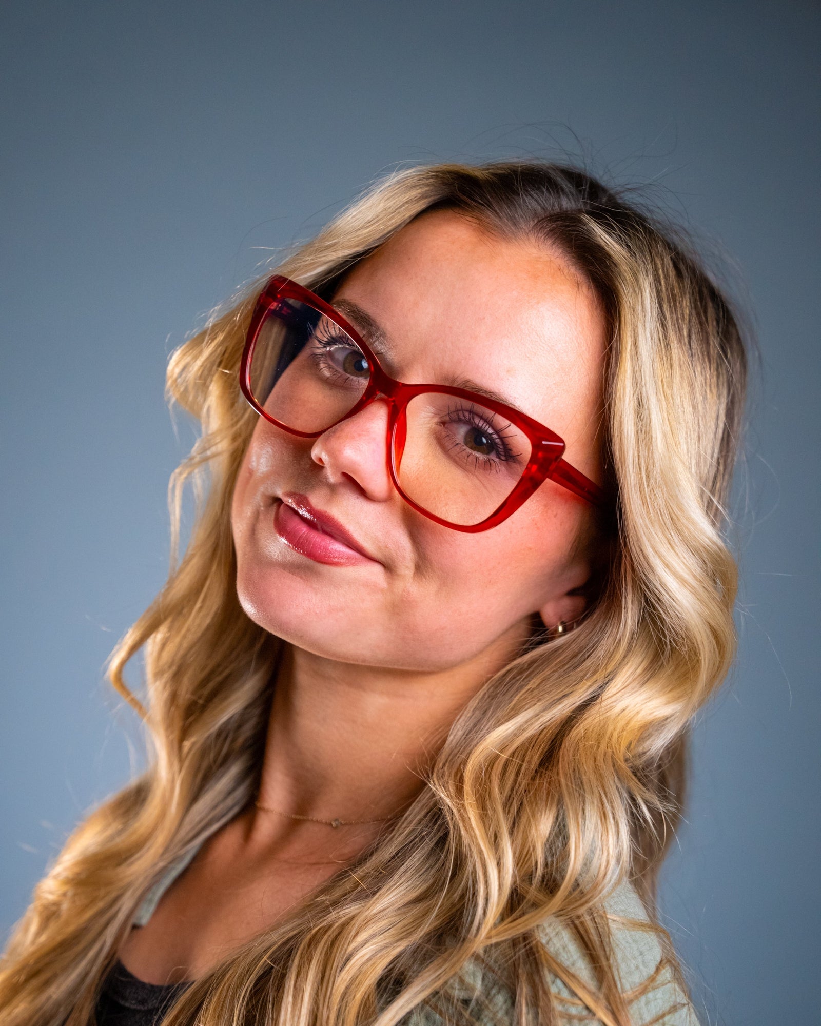 Model wearing LadyBoss Alloras eyeglasses in Cardinal Crystal