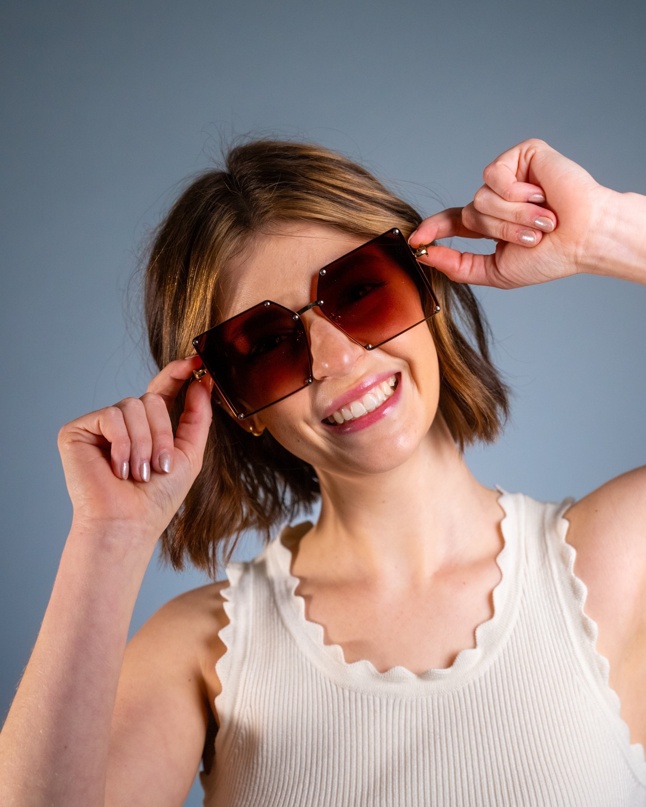 Model wearing LadyBoss Elevations sunglasses in Amber, front view #frame color_amber