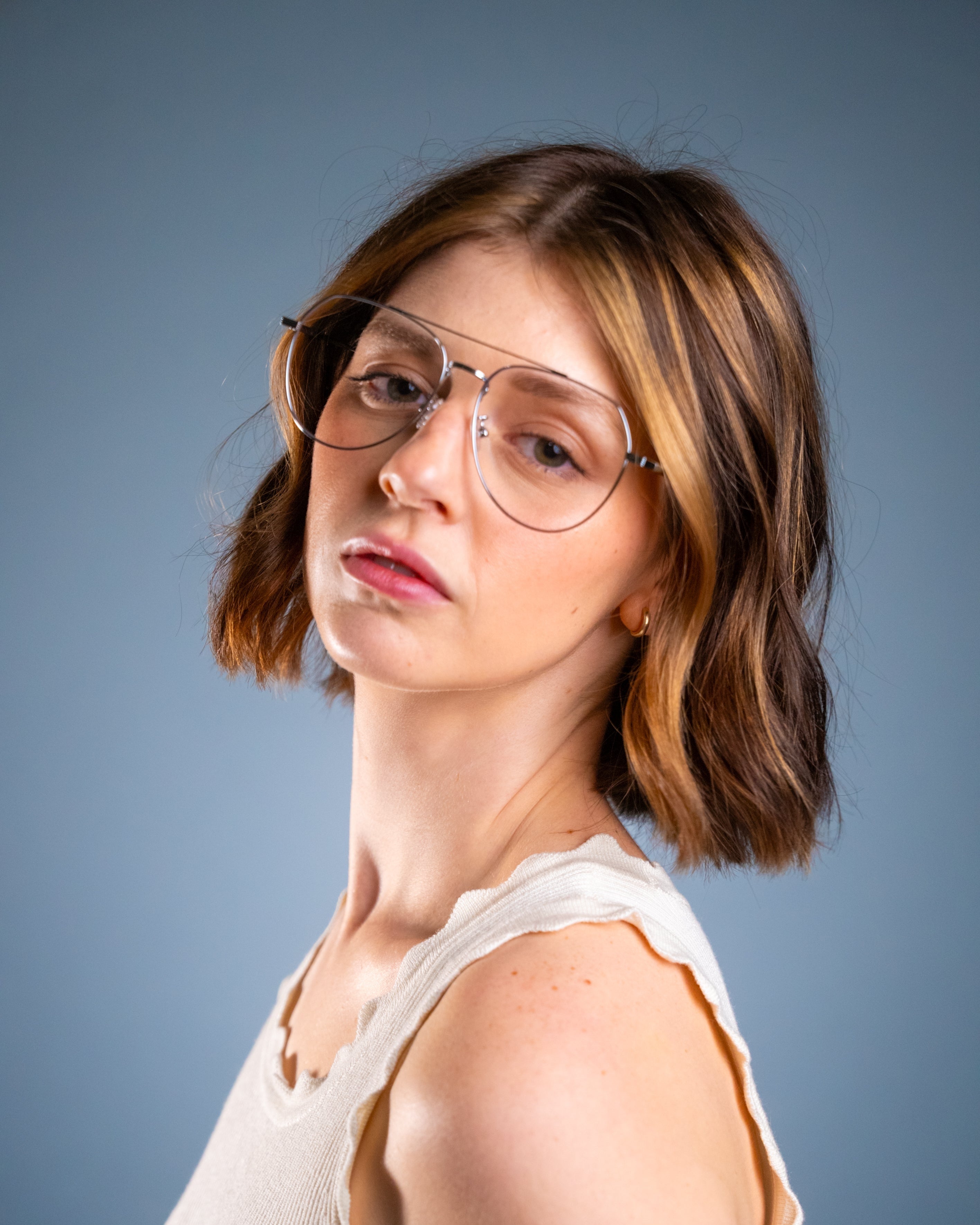 Model wearing LadyBoss Evocatives eyeglasses in Silver #frame color_silver