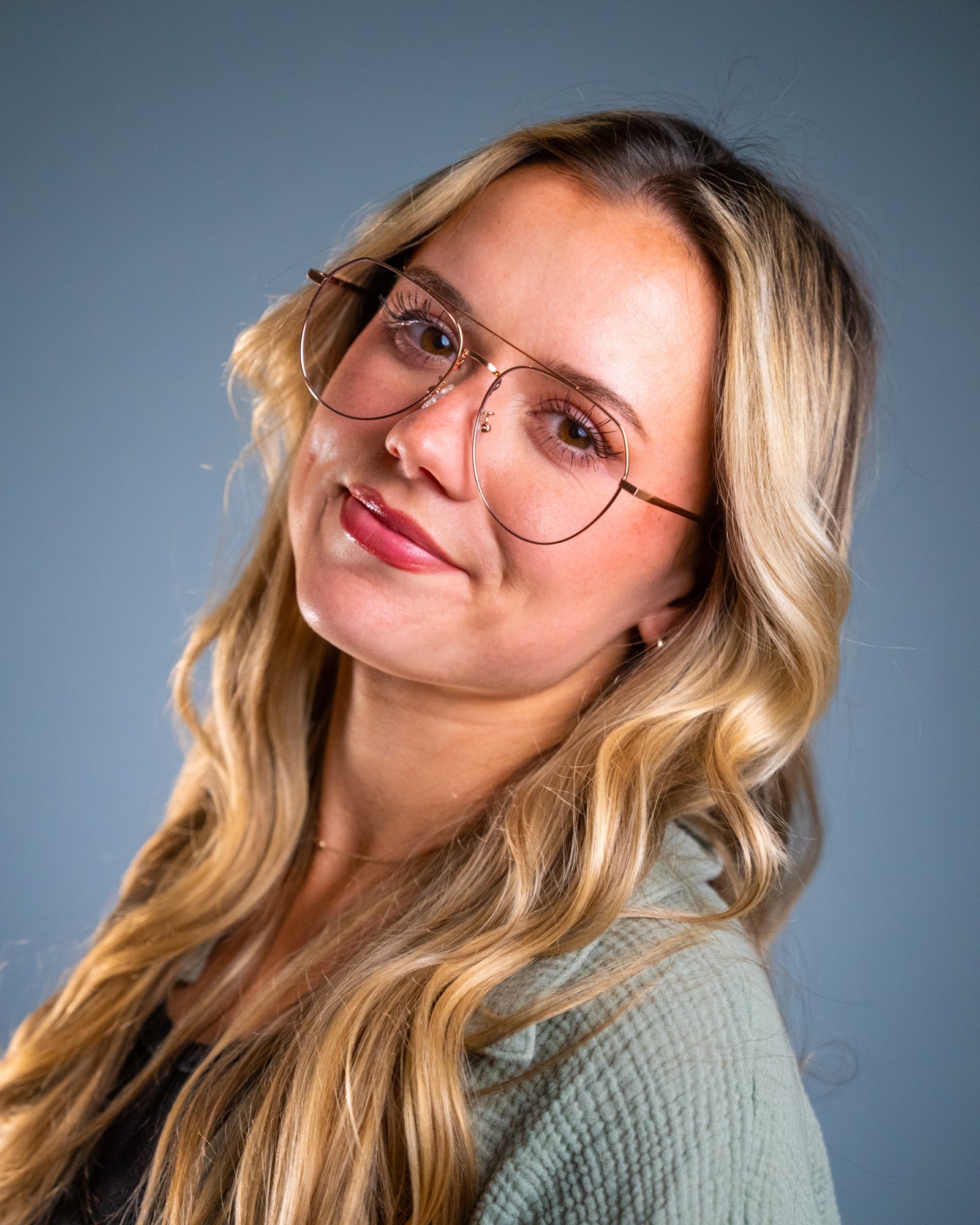Model wearing LadyBoss Evocatives eyeglasses in Rose Gold
