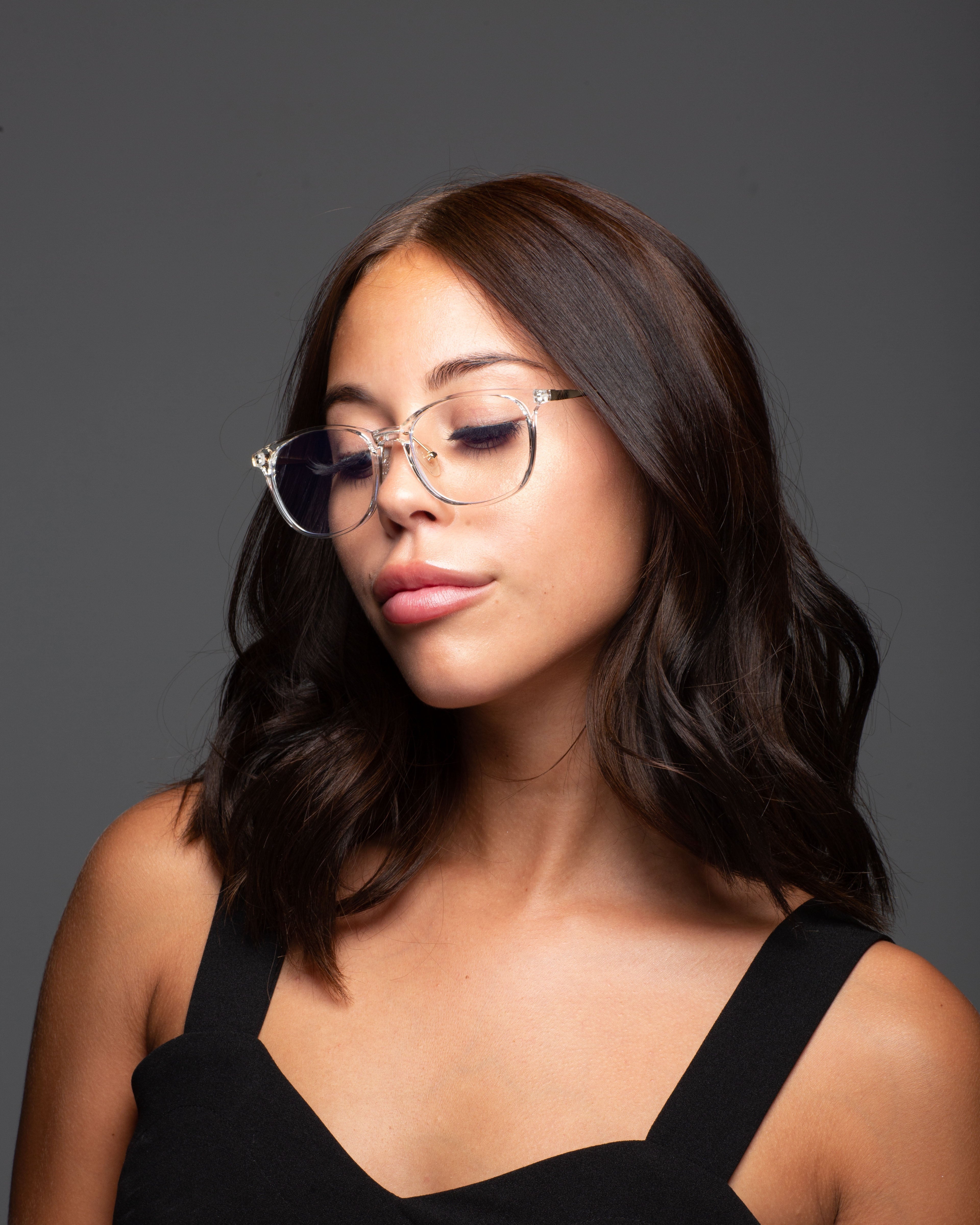 Model wearing LadyBoss Minimals eyeglasses in Crystal Clear #frame color_crystal clear