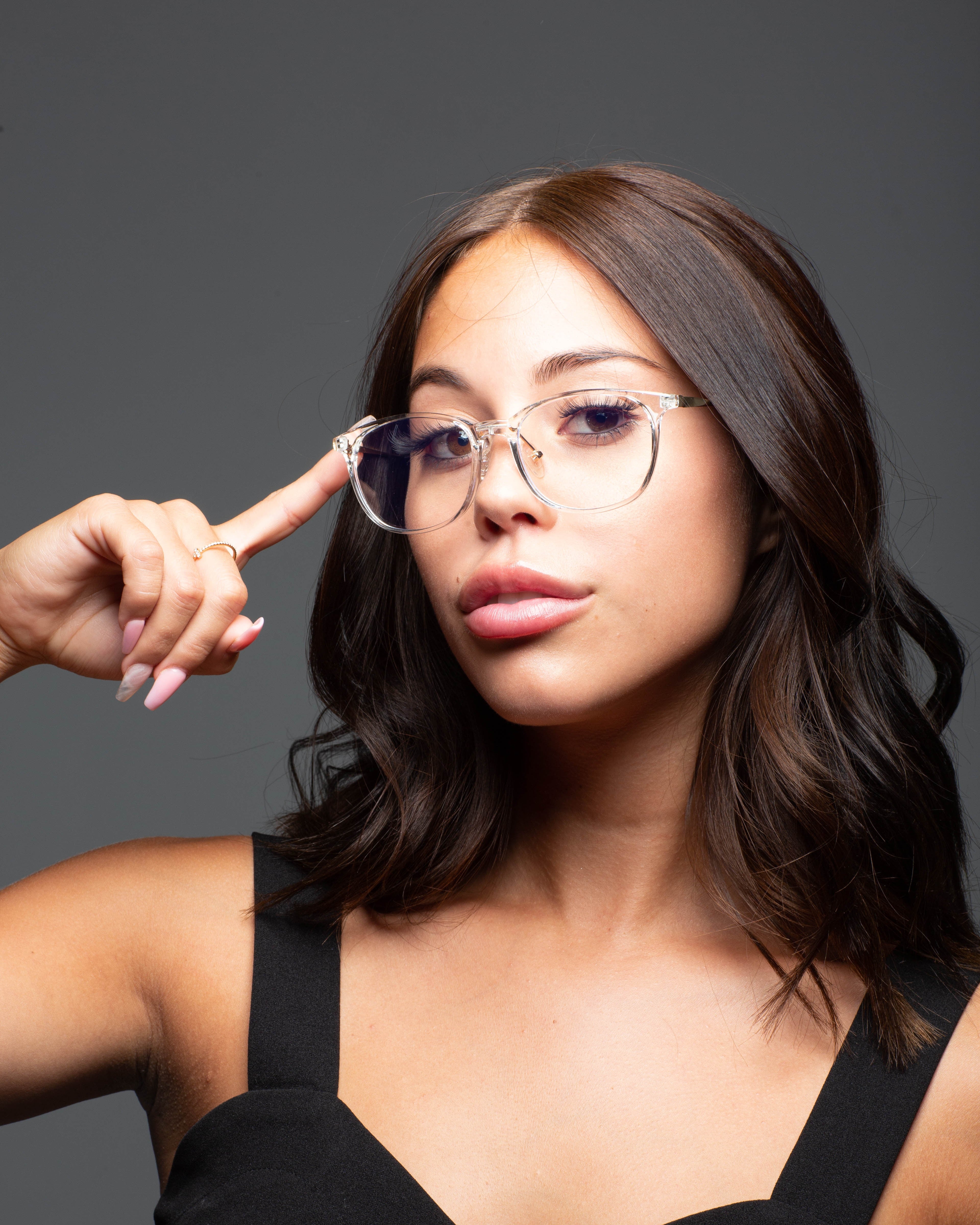 Model wearing LadyBoss Minimals eyeglasses in Crystal Clear #frame color_crystal clear